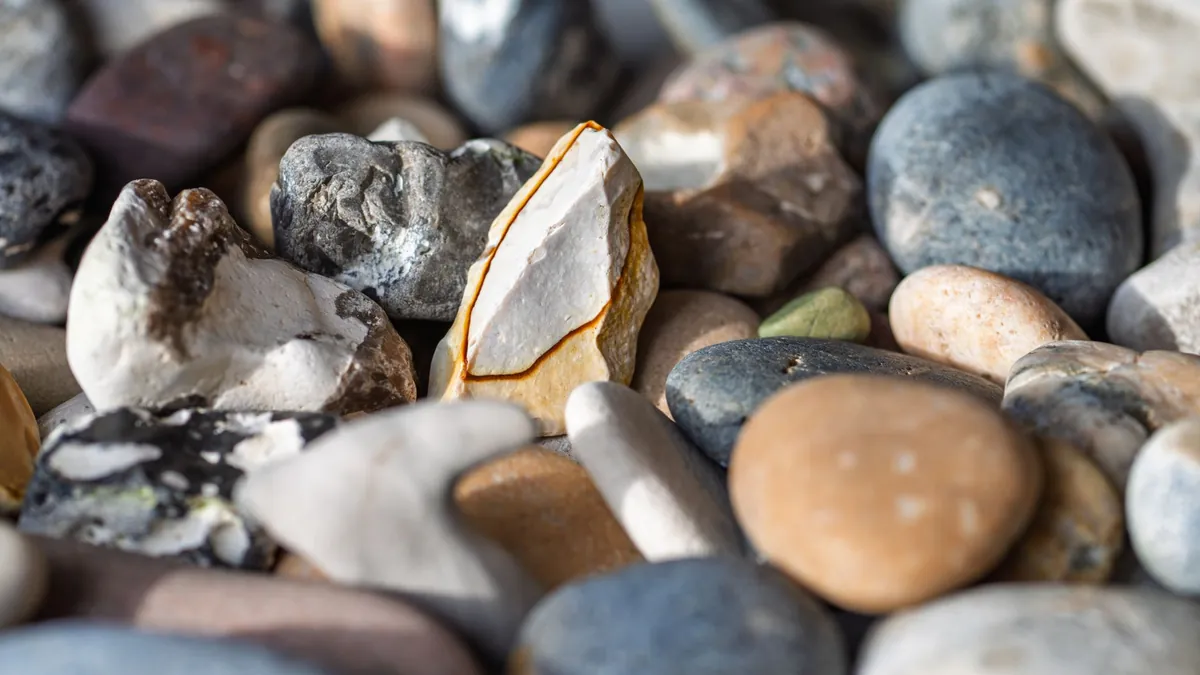 Smooth polished pebbles in warm tones, seen close up